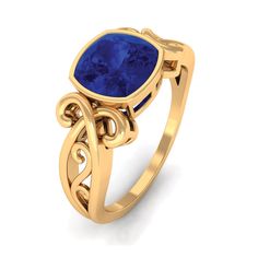 a gold ring with a blue stone in the center and filigrees around it