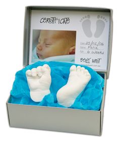 an open box with two baby feet in it