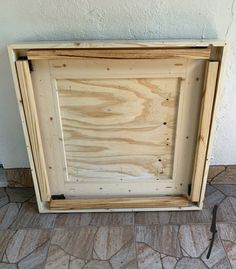 a wooden frame sitting on top of a stone floor