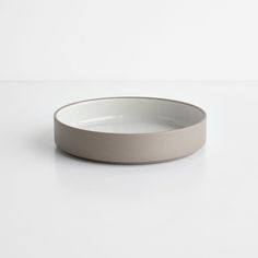 an empty white bowl sitting on top of a table