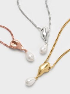 Elegant and understated, this Corrine pearl necklace in shiny silver features a single teardrop-shaped faux pearl that hangs off a sculptural rose gold-tone pendant. The smooth curves of the pearl is juxtaposed against the fluid lines of the pendant -- the result is striking and sophisticated. With pearls trending right now, this is the perfect piece to add to your jewellery collection right now. Rose Gold Pearl Necklace, Pearl Trend, Silver Pearl Necklace, Necklace Elegant, Charles Keith, The Pearl, Shiny Silver, Jewellery Collection, Trending Shoes