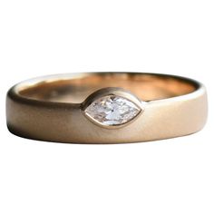 a gold ring with a white diamond in the center