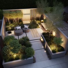 an aerial view of a garden at night with lights on the patio and seating area