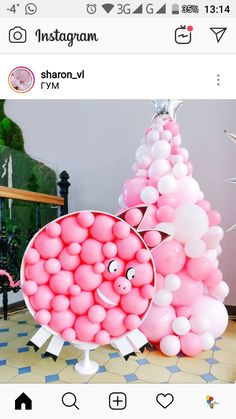 a pink balloon christmas tree with balloons on it