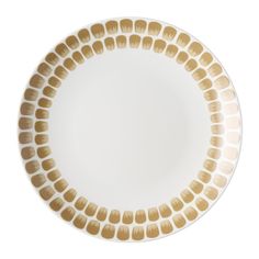 a white and gold plate with circles on the rim, set against a white background