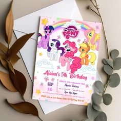 a pink pony birthday party card on top of a white envelope