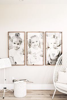 three framed pictures hang on the wall next to a white chair in a living room