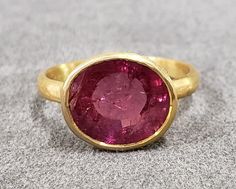 1. 18k Gold Pink Tourmaline Ring 2. Rubellite 3. Gemstone - Pink Tourmaline 4. Jewelry Type - Gold Ring 5. Total Weight - 3.470 Gram Approx.  6. Tourmaline Weight - 4.40 Carats  7. Gold Weight - 2.590 Grams Approx.  8. Tourmaline Size - 9 x 11 MM Approx. 9. Gold Purity - 18k 10. Handmade Items 11. Band Size - 2.35 MM 12. 18k Stamped  13. AAA Quality 14. Stackable Ring 15. 1 Quantity Available 16. Ready to Dispatch in 1 - 2 days.  Pictures are taken under natural and day light. Rubellite Ring, Graduation Rings, Pink Tourmaline Ring, Solid Gold Ring, Pink Shade, Solid Gold Rings, Tourmaline Ring, Valentine's Gift, Jewelry Inspo