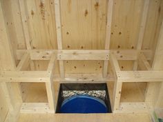 there is a blue barrel in the middle of some wooden shelves that are being built