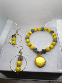 Beautiful Yellow And Gray Charm Bracelet With Matching Earrings Set Silver Jewelry With Round Beads For Fashion, Adjustable Costume Jewelry Sets With Round Shape, Yellow Metal Hoop Earrings As Gift, Yellow Dangle Jewelry With Matching Earrings, Yellow Metal Jewelry As Gift, Adjustable Yellow Jewelry Sets For Gift, Yellow Metal Jewelry Gift, Adjustable Yellow Dangle Jewelry, Yellow Beaded Metal Jewelry