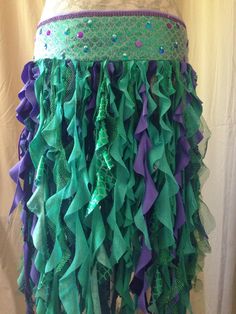 a green and purple skirt with lots of ruffles