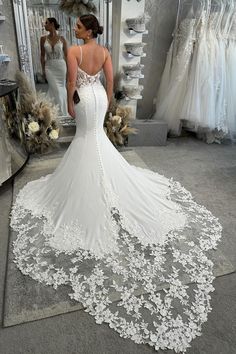 a woman is looking at her wedding dress