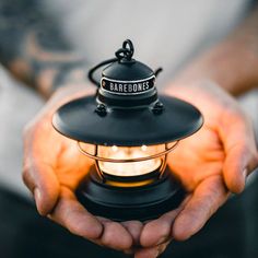 a person holding a lantern in their hands with the word bare bones written on it