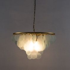 a chandelier hanging from a ceiling in a room with white walls and flooring