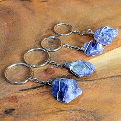 three amethyst quartzite key chains on a wooden table