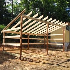 a wooden structure sitting on top of a dirt field