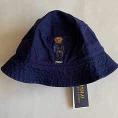 100% Authentic Mens Polo Ralph Lauren Polo Bear Twill Bucket Hat (Msrp $69.50). This Hat Is Brand New With Tags! Polo Ralph Lauren's Twill Bucket Hat Features The Iconic Polo Bear Dressed In A Denim Jacket, Cable-Knit Sweater And Jeans. Color: Newport Navy Size: S/M Seamed Brim Embroidered Ventilating Eyelets 1" Band Around The Crown Signature Ralph Lauren Polo Bear And "Polo" Embroidered At Front Size S/M: 22.75" Inner Circumference Sweatband At The Interior Cotton Ralph Lauren Bucket Hat, Ralph Lauren Polo Bear, Sweater And Jeans, Polo Bear, Ralph Lauren Denim, Sweaters And Jeans, Ralph Lauren Polo, Jeans Color, Cable Knit