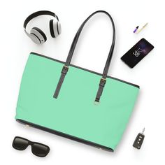 Large Leather Tote Shoulder Bag, Seafoam Green. This versatile tote bag is tailored for the modern woman who prioritizes practicality and style. This bag was created with a large interior and well-thought-out compartments, this tote effortlessly caters to your needs for any occasion. Designed with functionality in mind, it seamlessly blends into your busy lifestyle while making a fashion-forward statement. This tote allows you to showcase your individuality effortlessly. Lightweight yet sturdy, Green Rectangular Laptop Bag For On-the-go, Trendy On-the-go Tote Laptop Bag, Green Casual Office Bag, Modern Green Shoulder Bag With Large Capacity, Green Tote Shoulder Bag For Office, Functional Shopping Bags With Handles, Green Large Capacity Office Bag, Casual Green Laptop Bag For Daily Use, Green Shoulder Bag For Office