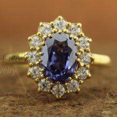 a tan gold ring with an oval blue sapphire surrounded by white and yellow diamond accents