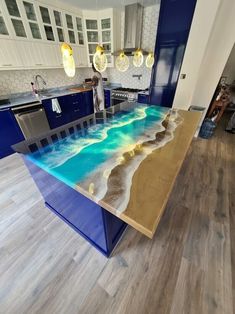 a kitchen with an island made out of blue and white sand on the counter top