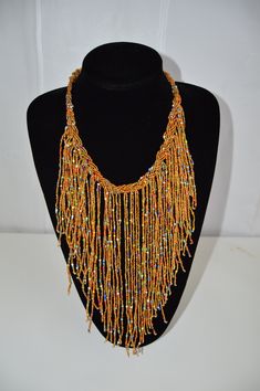 This Beaded African necklace is made with the finest quality beads that bring out mother earths most beautiful colors. It is traditionally worn by Kenyan women on special occasions such as weddings. Normal Fit. One size fits all. Perfect gift for that Special Person in your life. Yellow Beaded Necklaces With Large Beads For Festivals, Yellow Beaded Necklace With Large Beads For Festivals, Elegant Multicolor Beaded Necklaces With Dangling Beads, Festive Yellow Jewelry With Colorful Beads, Bohemian Beaded Necklaces For Celebration, Multicolor Beaded Necklaces With Gold Beads For Festivals, Colorful Round Beaded Necklaces For Celebration, Multicolor Gold Beads Jewelry For Celebration, Colorful Round Beads For Celebration