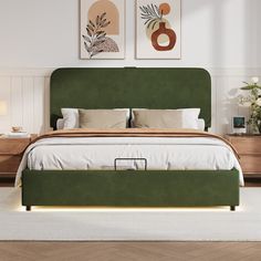 a bed with green headboard and foot board in a white walled room, with two paintings on the wall above it