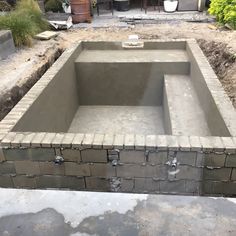 an unfinished pool in the middle of a yard