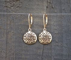 "14k Gold dangle earrings, Filigree Round mandala earrings, beautiful and delicate ethnic earrings.  Gorgeous, solid gold bohemian earrings with a dangling domed circle. The circle is designed as a delicate mandala with spiraling floral motifs. These unique, Indian style, handmade earrings are part of my ethnic jewelry collection. These lightweight and delicate 14k gold drop earrings will become your favorite go-to accessory for every occasion. Get these earrings for yourself or as a meaningful Elegant 14k Gold Medallion Jewelry, Elegant Rose Gold Medallion Jewelry, 14k Gold Filigree Dangle Jewelry, Elegant Yellow Gold Medallion Earrings, Intricate Rose Gold Sterling Silver Jewelry, Elegant Engraved Circular Jewelry, Gold Round Pendant Jewelry With Elegant Design, Fine Jewelry Dangle Earrings With Filigree, Gold Round Pendant With Elegant Design