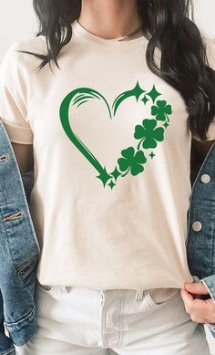 Lucky Clover Heart St Patrick's Day Graphic Tee. Most t-shirt colors are 52/48 cotton/polyester blend. Athletic Heather & Black Heather are 90/10 cotton/polyester. White, cream, citron, pink, canvas red, lilac, mint are 100% cotton. Ash is 99/1. Please note that this item ships directly from the supplier in 1-3 days. Returns must be started within 7 days of receipt of product. If ordering multiple products, products may ship separately. Spring Heart Graphic Tee, Spring Heart-shaped Graphic Tee, Green Crew Neck T-shirt With Heart Graphic, Suede Outfit, Leopard Outfits, Burgundy Outfit, Plus Size Tees, Pink Canvas, Heart Graphic