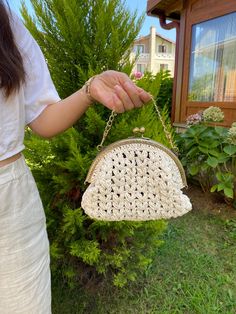 This handmade bag is knitted with paper rope, giving it a unique and stylish look. With a size of 26cm, it offers ample space for your belongings. Jute Crochet Bag With Braided Handles, Chic Beige Braided Crochet Bag, Crochet Jute Bag With Top Handle, Chic Jute Crochet Bag With Top Handle, Chic Braided Crochet Bag For Daily Use, Chic Natural Crochet Bag With Braided Details, White Hand-knitted Crochet Bag, White Hand Knitted Crochet Bag, Chic Natural Braided Crochet Bag