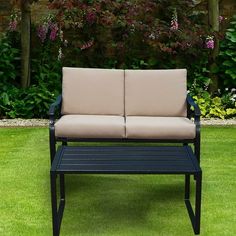 a couch sitting on top of a lush green field