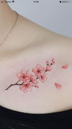 a woman's chest with pink flowers on it