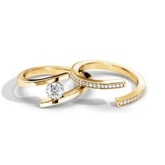 two gold rings with diamonds on them