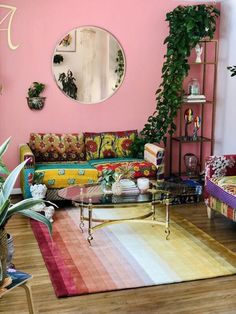 a living room with pink walls and colorful furniture