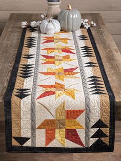 a quilted table runner with an autumn theme