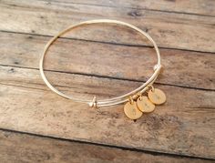 Personalized Gold Initial Bracelet. Have this bangle bracelet personalized with any letters! Personalized jewelry makes the perfect gift for so many occasions. Kids initials, grandkids initials, etc can be hand stamped on each 9.5mm brass disc. 1 letter can be stamped per disc. Each charm measures 9.5mm which makes this bracelet dainty and simple, yet full of personal meaning! Each personalized bracelet is custom made to order. Thanks for looking! Visit my shop for more personalized jewelry: www Adjustable Gold Name Bracelet For Best Friend, Adjustable Monogram Name Bracelet As A Gift, Adjustable Monogram Name Bracelet For Gift, Personalized Charm Bangle Bracelet, Personalized Bangle Charm Bracelet, Adjustable Initials Bangle Jewelry, Personalized Initials Charm Bracelet Adjustable, Adjustable Initials Charm Bracelet For Personalized Gift, Adjustable Initials Bracelets For Bridesmaid Gift