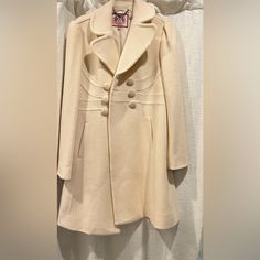 This Is A Brand New Juicy Couture Knee Length Double Breasted Wool Coat, Extra Buttons On The Inside Lined Coat Made Of Wool And Cashmere Never Worn.. I Am 5 Foot Seven, 140 Pounds For Reference Bust Pit To Pit 18". Waist Is Approximately 16.5" Across Laying Flat. Length Is Approximately 35". Sleeve 24.5 70% Wool / 20% Poly / 10% Cashmere Cream Pea Coat For Office In Winter, Cream Wool Long Sleeve Outerwear, Fitted Beige Pea Coat For Winter, Cream Wool Coat With Button Closure, Beige Wool Coat For Winter Tailoring, Cream Wool Coat For Winter Office Wear, Fitted Winter White Wool Outerwear, Chic Long-sleeve Wool Coat In Winter White, Cream Fitted Long Wool Coat