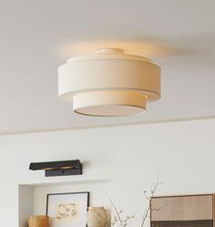 a living room filled with furniture and a light fixture above the couches in front of them