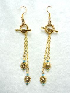 Bright aqua glass beads and goldtone bali beads on delicate goldtone chain and small toggle clasps. 3 1/2" L. All Togglearrings are interchangeable.  $17.49 Artist Jewelry, Aqua Glass, Earring Designs, Artistic Jewelry, Gold Plated Chains, Jewelry Tutorials, Designer Earrings, Beaded Earrings, Handcrafted Jewelry