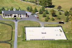 an aerial view of a large house in the middle of a field