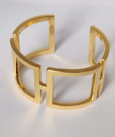 10 Karat Yellow Gold Rectangle Cuff Bracelet , 3 x 1.5 mm thick x mm 31 .25 wide. This is one of my early designs. I was using the simple rectangle in a curved state for the ultimate in expression of sculpture and a piece of jewelry. Clean, simple and elegant. This cuff will go from daytime to evening easily. Less is more. This design will last you your lifetime and easily passed down to you daughter. Made to order please allow 4 weeks delivery. $1,675 Elegant Yellow Gold Cuff Bracelet For Formal Occasions, Timeless Gold Cuff Bracelet, Modern Gold Bracelets For Formal Events, Elegant 14k Gold Cuff Bracelet For Formal Occasions, Elegant Rectangular Bracelets For Formal Occasions, Elegant Rectangular Bracelets With Polished Finish, Elegant 14k Gold Cuff Bracelet With Polished Finish, Gold Open Cuff Elegant Jewelry, Luxury Rectangular Bracelets For Formal Occasions