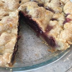 a pie that has been cut in half and is on top of a glass plate