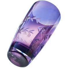 a purple glass vase sitting on top of a table