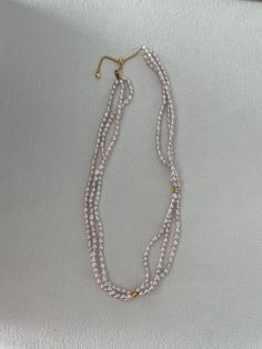 Elevate your style with this luxurious triple strand pearl necklace, a statement piece that combines timeless elegance with modern sophistication. Featuring three delicate strands of hand-selected freshwater pearls, this necklace showcases the unique beauty of each pearl's natural shape and lustrous shine. The strands are expertly intertwined and accented with sterling silver beads plated with 18K gold, adding a touch of opulence to the design. Material: Freshwater Pearls, Sterling Silver with 1 Natural Pearl Necklace, Pearl Collection, Unique Beauty, Pink Tone, Necklace Sterling Silver, Ring Collections, Personalized Necklace, Natural Pearls, Baroque Pearls