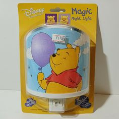 a winnie the pooh night light is in its packaging