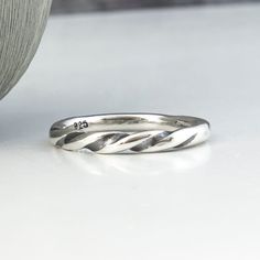 This sterling silver twisted stacking ring is perfect for both men and women. Its elegant twist design adds a unique touch to any outfit, making it perfect for everyday wear. Whether worn alone or stacked with other rings, this versatile piece is a must-have for any jewelry collection. The listing is for ONE ring. You can receive an automatic 20% discount when purchasing two or more. The ring is made to order therefore there can be some variations from photo. DETAILS:Size: Made to order in US si Stackable Twisted Rings For Promise, Modern Twist Stackable Rings For Promise, Modern Twist Stackable Twisted Promise Rings, Modern Twisted Shape Promise Ring, Modern Twisted Promise Ring, Modern Twist Twisted Promise Ring, Adjustable Stackable Midi Rings With A Modern Twist, Modern Twist Stackable Adjustable Midi Rings, Minimalist Adjustable Twisted Rings