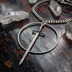 Embrace your inner warrior with this unique necklace featuring a bold sword design encircled in silver, adding an edgy touch to any outfit. Feel empowered and stylish at the same time. Metals Type: Zinc alloy Inner Warrior, Feel Empowered, Circle Pendant Necklace, Unique Necklace, Circle Pendant, Unique Necklaces, Types Of Metal, Zinc Alloy, Gems