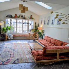 a living room filled with lots of furniture and decor on top of a carpeted floor