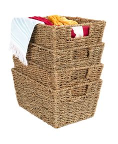 three wicker baskets stacked on top of each other with towels and blankets in them