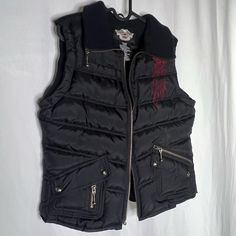 Harley Davidson Motorcycles Biker Vest Puffer Riding Vest With Adjustable Cord In Back Of Vest To Block Wind. Perfect Condition, Brand New Without Tags! Red And Black All Pockets Are Functional. Logo And Detailing On Inside. Soft Warm Lined Material. Embroidered Design On Front And Logo Embroidered On Back. Measurements For Waist And/Or Hip Are Taken Zipped Or Buttoned Up And Laid Comfortably Flat Then X2 For Total Circumference (Inches) Length From Front: 22” Length From Back: 22” Shoulder Widt Riding Vest, Vest Puffer, Harley Davidson Jacket, Biker Vest, Harley Davidson Motorcycles, Puffer Vest, Embroidered Design, Logo Embroidered, Red And Black